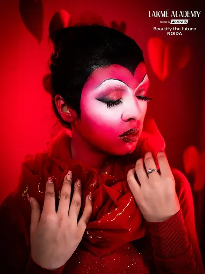 A dramatic Valentine's-themed fantasy look. The red and white face paint and glitter lips create a bold and artistic interpretation of the day of love.