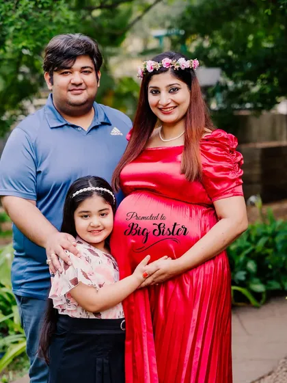 "Promoted to Big Sister!" This family portrait is a sweet announcement, with the focus on the daughter who is so excited about her new role.