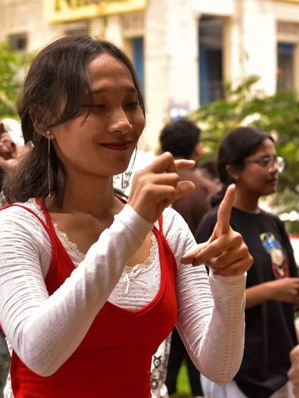 A volunteer and a participant share a moment of connection while practicing sign language. These one on one interactions are at the heart of building an inclusive community.