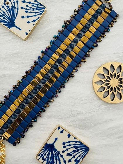 A blue and gold beaded bracelet, showcasing the elegant and contemporary jewellery designs at our events.