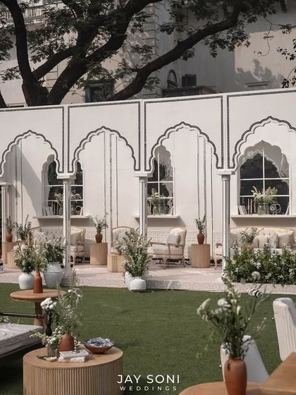 A clear view of the lounge pavilion's facade, with its clean lines and traditional arch details, providing a beautiful backdrop for the outdoor seating.