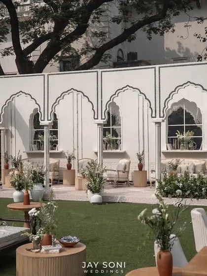 A clear view of the lounge pavilion's facade, with its clean lines and traditional arch details, providing a beautiful backdrop for the outdoor seating.