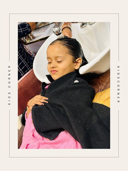 A little girl relaxing at the hair wash station, completely at ease. We ensure a comfortable and safe experience for our youngest clients.