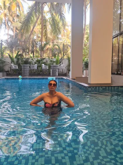 Another shot from the pool in Goa, showcasing a confident and relaxed moment. The tropical background adds to the holiday feel.