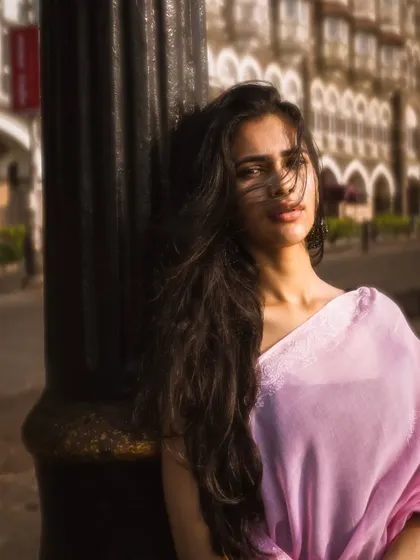 The wind catches her hair perfectly in this shot, adding a dynamic and romantic feel to the portrait against the lamppost.
