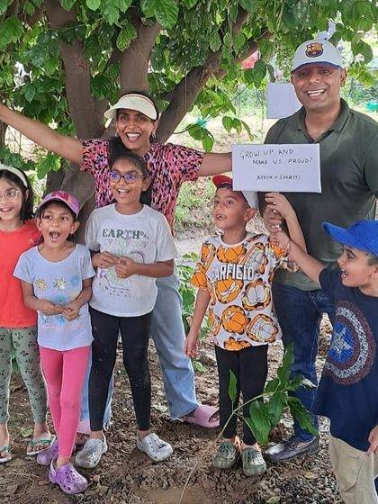 A family from Calpro Specialties, including several enthusiastic children, poses proudly after their plantation drive at Aravali Creek.