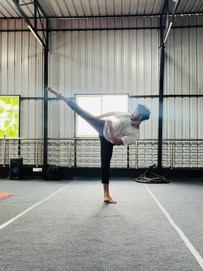 Another student demonstrating a high kick, a testament to their hard work in our flexibility and conditioning sessions.