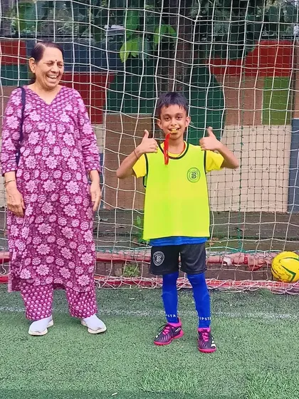 A proud grandmother celebrates with her grandson, a deserving Player of the Month.