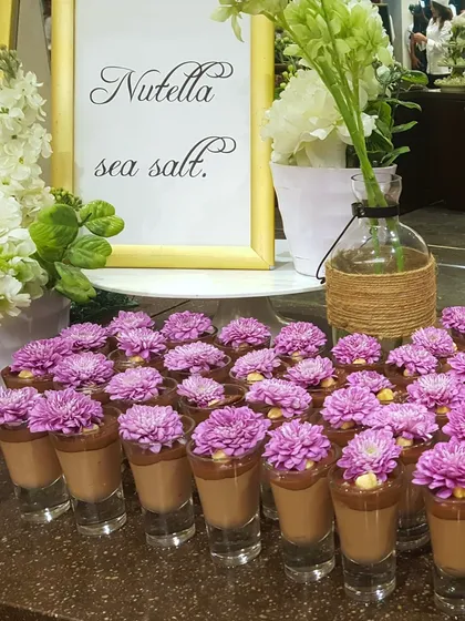 Nutella sea salt mousse shots, each topped with a beautiful purple chrysanthemum. This dessert combines the popular flavour of Nutella with a surprising floral elegance.