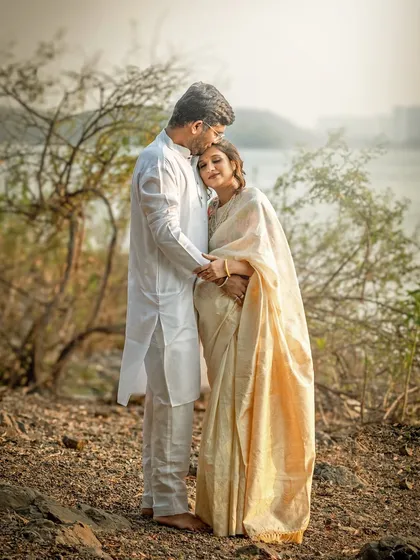 An intimate and tender embrace by the water. This photo captures the deep emotional connection and the quiet support between the partners during this special time.