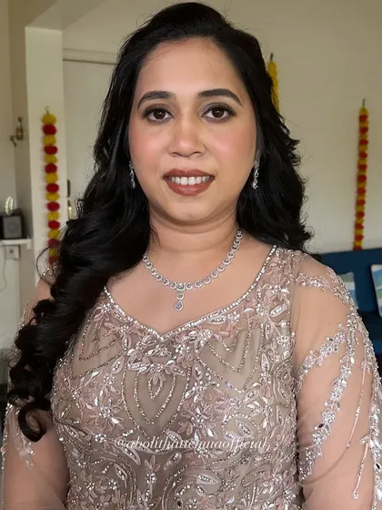 A closer view of the makeup for this elegant party look. The focus is on clean skin, defined brows, and a warm, neutral lip color.