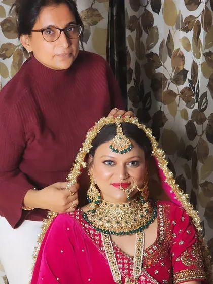 A final check before the bride is ready. I take pride in making sure the entire look, including the placement of the dupatta and jewelry, is flawless.
