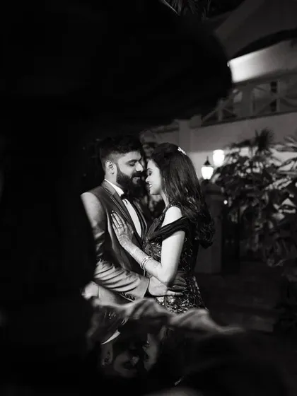 A duplicate of image 87, a romantic black and white photo of a couple at night, framed by a fountain.