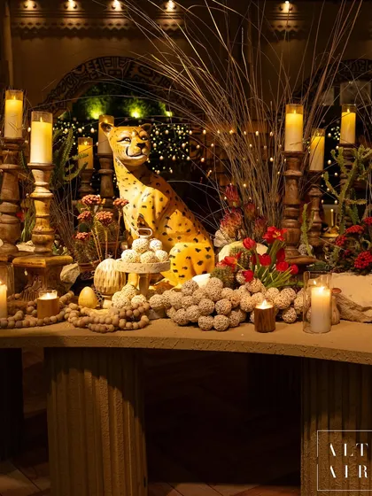 I love adding unexpected, artistic elements to my designs. This cheetah sculpture, surrounded by desert grasses and candles, was a playful and chic centerpiece for the 'Mid-Century Mod' event, adding a touch of wildness to the sophisticated decor.