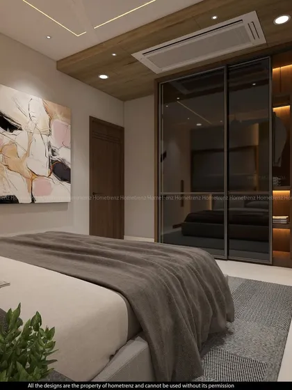 A guest bedroom wardrobe with smoked glass sliding doors. The design is sleek, modern, and helps to make the room feel more spacious.