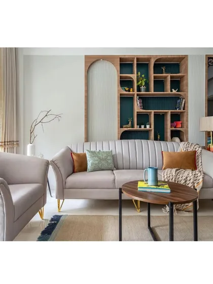 A closer view of the seating area, showing the comfortable, modern sofa and armchair. The tripod floor lamp adds a touch of mid-century modern flair to the space.