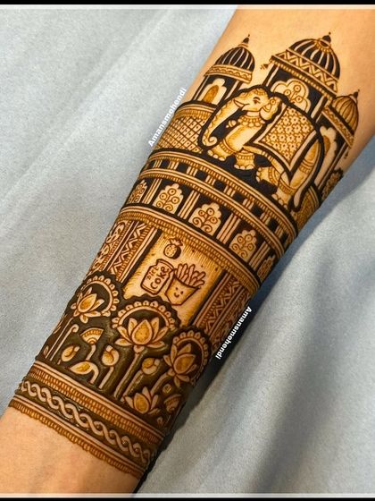 A custom bridal arm design featuring a royal elephant, a palace, and a cute, personalized cartoon of fries and a drink, reflecting the couple's personality.
