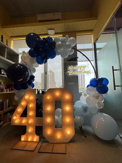 The 40th birthday setup from a different angle, highlighting the depth of the balloon arch.