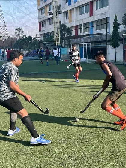 An intense face-off between two players during a Sunday morning practice. This is where skills are sharpened and competitive instincts are honed.