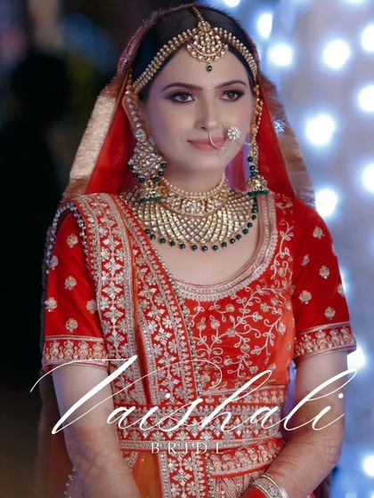 A beautiful, bright portrait of the bride, Vaishali, her smile and stunning green jewelry creating a look of pure elegance.