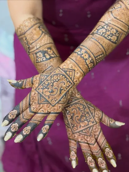 Both hands together, displaying the complete, symmetrical bridal design that is bold and beautiful.