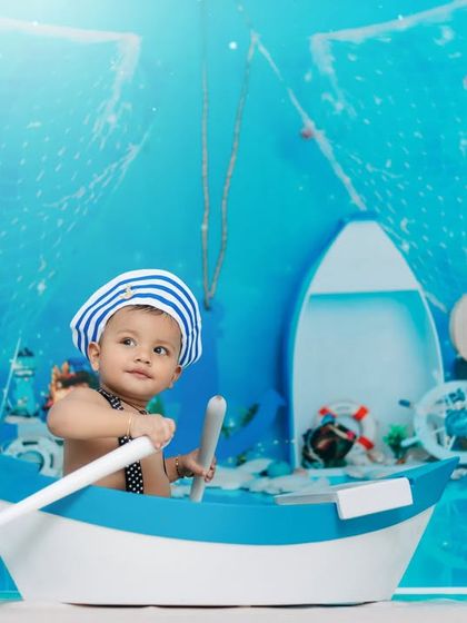 Adventure awaits on the high seas! A little sailor boy looks ready to set sail in our detailed nautical-themed studio setup.