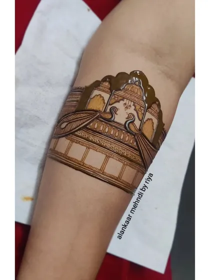 The henna paste is applied more thickly in certain areas to create depth and contrast in the design.