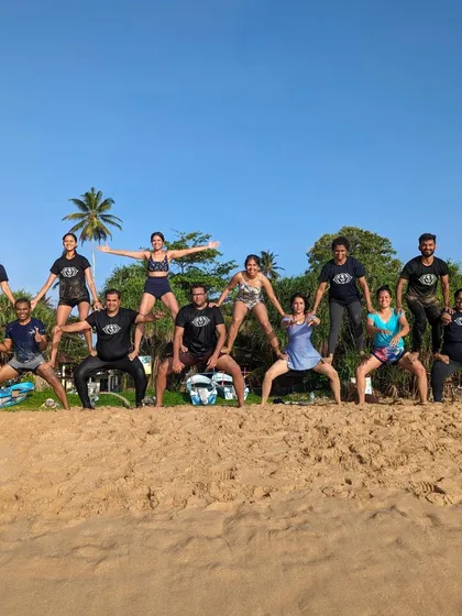 The full view of our human pyramid on the beach. This acro yoga challenge was a highlight, filled with teamwork, support, and a lot of laughter.