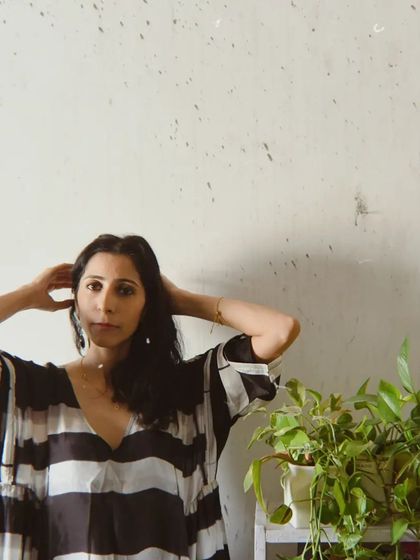 A portrait for House of Wandering Silk that incorporates natural elements, with plants framing the model.