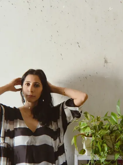 A portrait for House of Wandering Silk that incorporates natural elements, with plants framing the model.