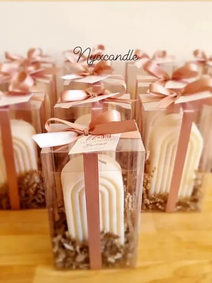 Our arch candle is a modern, minimalist design that is very popular for contemporary decor. Here it is shown in our new packaging, making it an elegant and stylish gift.
