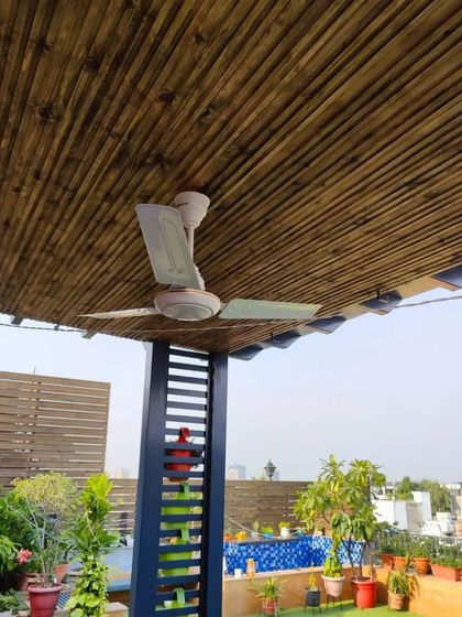 This shot shows the beautiful contrast between the natural bamboo ceiling of the pergola and the cool blue of the swimming pool in the background.