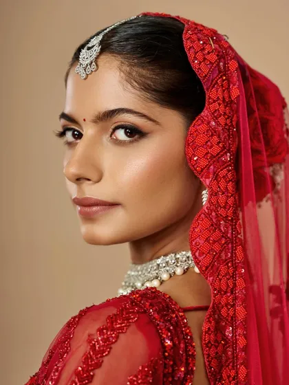 A powerful gaze from a classic red bride. The sharp winged liner adds a touch of drama, beautifully contrasting with the soft, glowing skin.