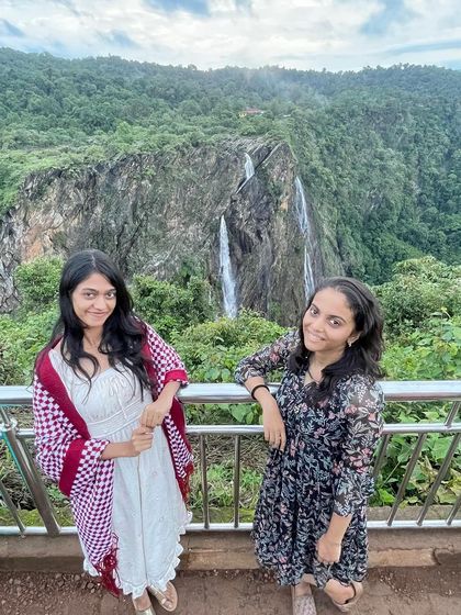 Two friends posing at the Jog Falls viewpoint.