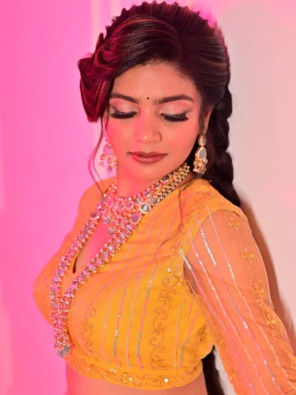 A close-up view of a full glam look for a traditional photoshoot. I focused on creating dramatic, winged eyeliner and perfectly blended eyeshadow to make the eyes pop, complementing the heavy jewellery and vibrant yellow outfit.