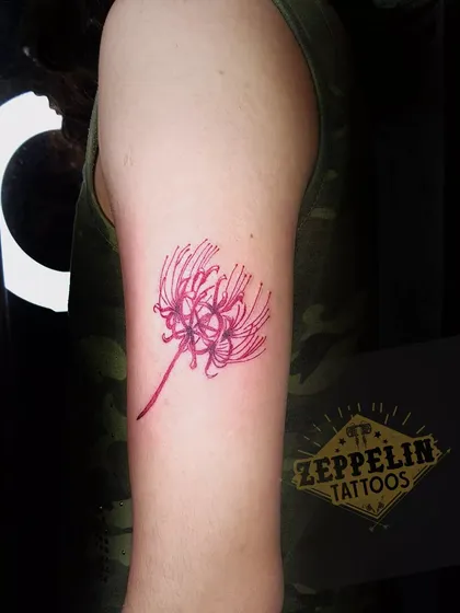A vibrant red spider lily tattoo. In my color work training, you will learn how to pack solid color and create delicate designs that heal beautifully.