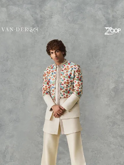 A full look at a layered Indo-Western outfit from the Vanderphool collection. The jacket is adorned with colorful floral embroidery, creating a vibrant yet elegant statement.