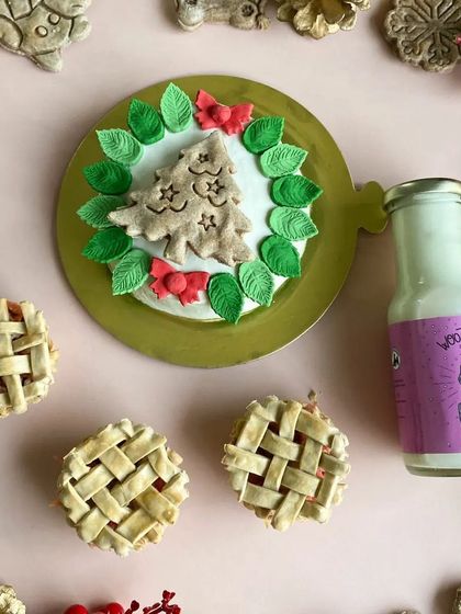 A perfect Christmas combo! This picture shows my festive cake, mini lattice pies, and a bottle of my special doggo eggnog, made with safe, pasteurized eggs.