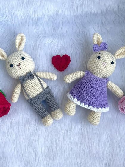 A lovely bunny couple, with the girl in a purple dress and the boy in smart grey trousers and a bow tie. They make a perfect wedding or anniversary gift.