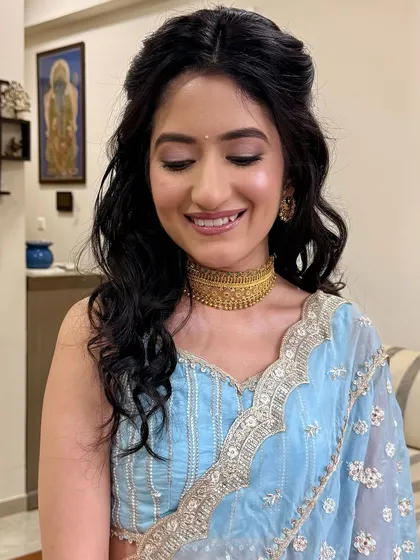 A close-up of the soft, shimmery eyeshadow and glowing skin. This look is all about enhancing her natural beauty for her special day.
