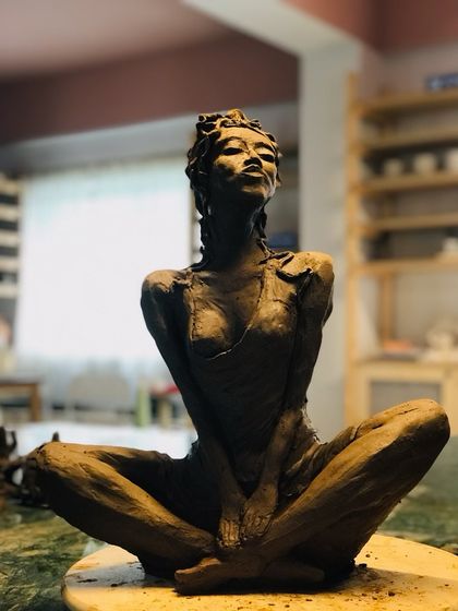 Another view of the 'Naughty Girl' sculpture, capturing her defiant and playful spirit.