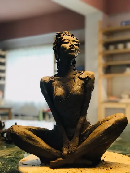 Another view of the 'Naughty Girl' sculpture, capturing her defiant and playful spirit.