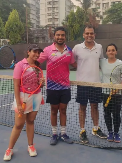 Players from different teams connecting at the net, highlighting the social aspect of our tennis events.