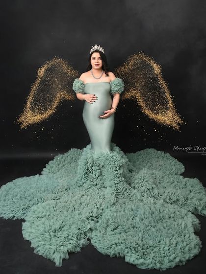 An angelic portrait with golden wings. This creative edit adds a magical touch, portraying the mom-to-be as a celestial guardian for her baby.