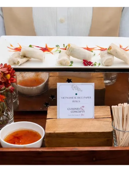 A tray of Vietnamese Rice Paper Rolls with a sweet chili dipping sauce. This light and refreshing appetizer is a popular choice for daytime events and offers a healthy yet flavourful option.