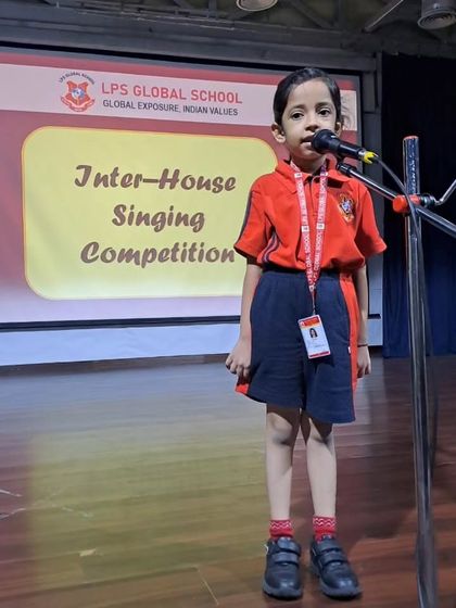 A student performs her chosen song with dedication during the Inter-House Singing Competition.