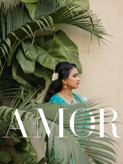A bride framed by lush green leaves. This portrait uses nature to create a beautiful, organic composition that highlights her serene beauty on her engagement day.