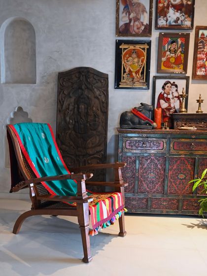 The Banarasi and Rabari throw styled in a room filled with Indian art and artifacts. The piece feels right at home in this collected, eclectic space.