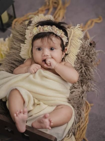 A curious little one. I love the textures in this shot, from the rustic basket to the soft, neutral-colored fabrics.