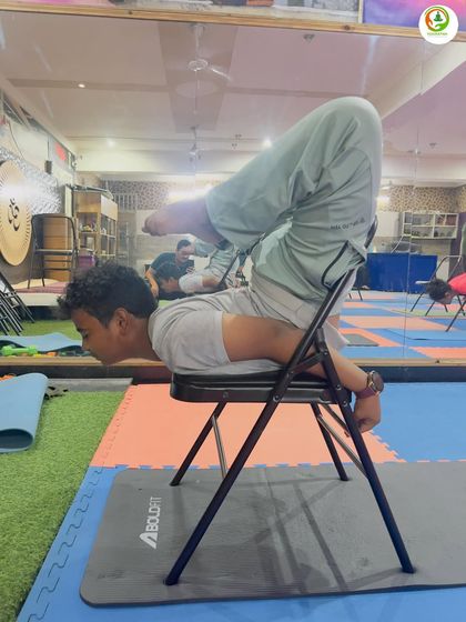 This is an advanced variation of Shalabhasana (Locust Pose) using a chair. It provides incredible strengthening for the entire back while the chair supports the body weight, allowing for a deeper expression of the pose.